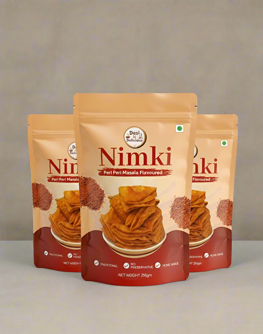 Three packages of Nimki snacks on a gray background