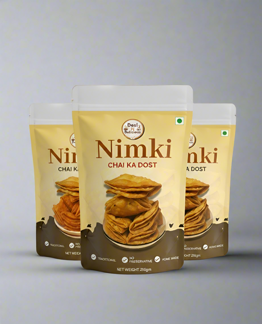 Three packages of Nimki with a gray gradient background